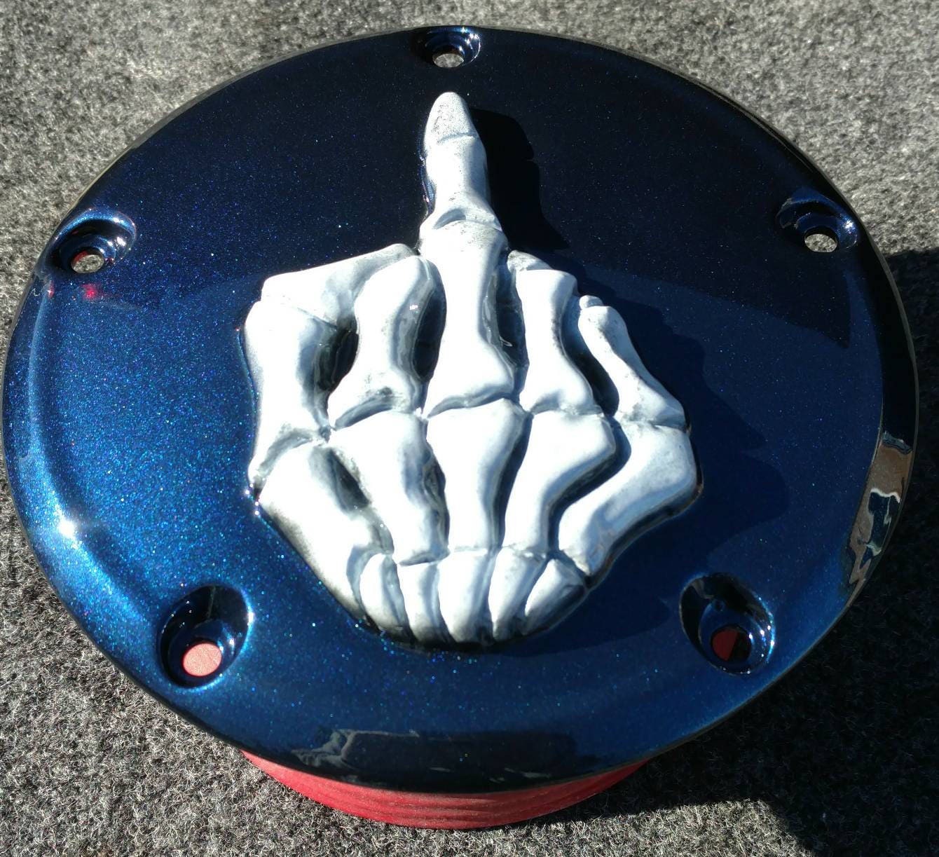 Middle finger on a Harley-Davidson derby and points cover