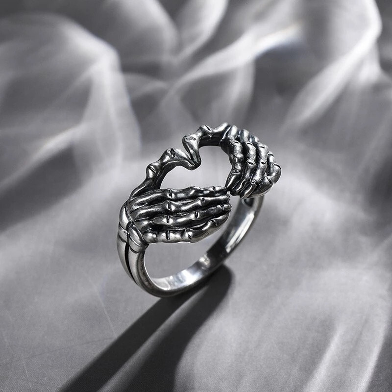 Retro skull hand with heart-shaped ring